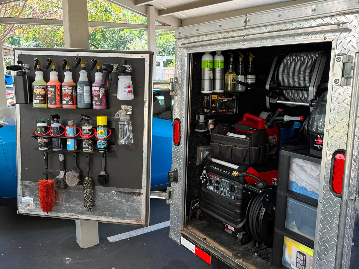 Organized products and professional equipment inside the JBS mobile detailing trailer